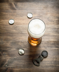 glass of beer with stoppers and a bottle opener.