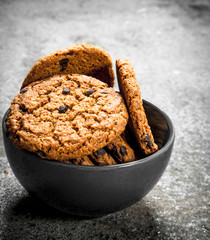 Oatmeal cookies with chocolate in a bowl.