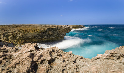 Fototapeta na wymiar Surf at caribbean coast. Long exposure, water looks dynamic.