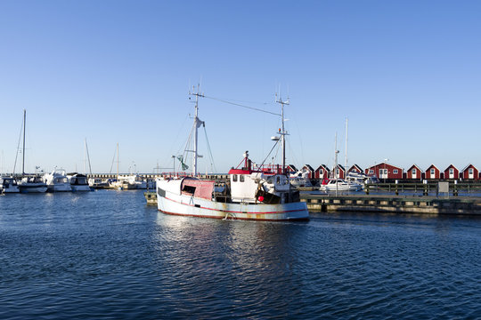 Laesoe / Denmark: A fishing cutter leaves the harbor of Vesteroe Havn