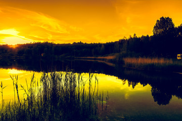 Scenic landscape of sunset sky over lake with reflection in the water, peaceful nature landscape
