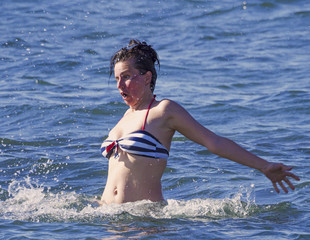 Badly frightened young woman in the ocean