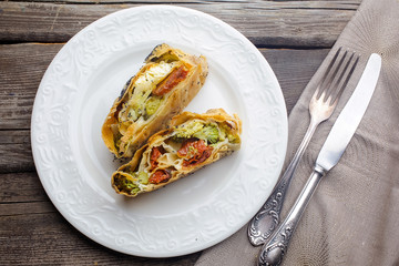 Strudel with cheese and sun-dried tomatoes. Homemade pie, strudel and snacks