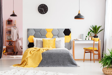 Yellow bedroom with black clock