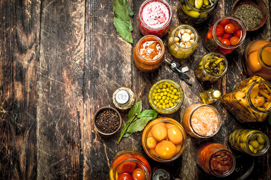 Preserved vegetables in glass jars with seamer.