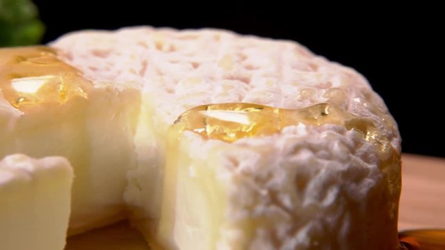 Appetizing French cheese watered with honey