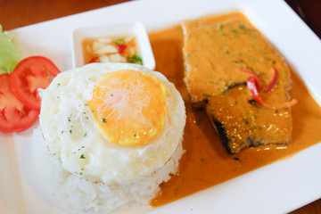 fried egg eating with spicy curry fish