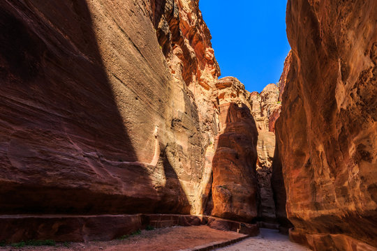 A narrow passage between steep rock formations in the siq at Petra the ancient City  Al Khazneh in Jordan