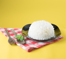 Cooked rice on plate with a spoon and fork , thai jasmine rice