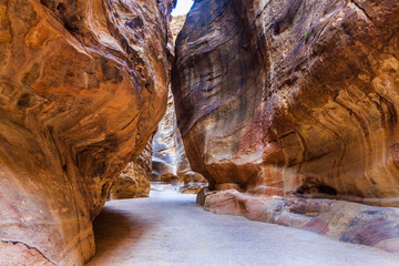 A narrow passage between steep rock formations in the siq at Petra the ancient City  Al Khazneh in Jordan