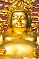 Golden chinese Buddha whith gold and red background