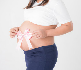 Pregnant woman with pink ribbon on the white