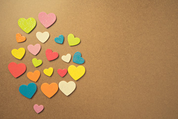 Flat lay design of colourful heart shape on wooden background for Love and valentine's day.