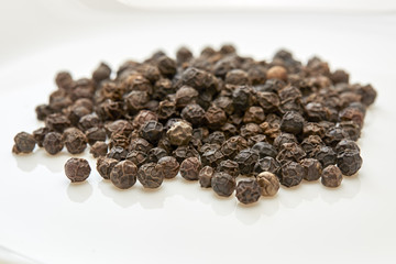 black peppers on white background