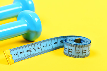 Gym and healthy lifestyle equipment. Dumbbells and measuring tape