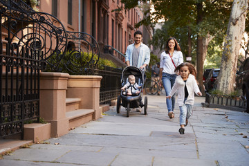 Family taking a walk down the street, close up