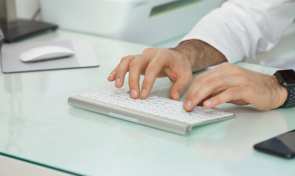 man hands near keyboard in modern office