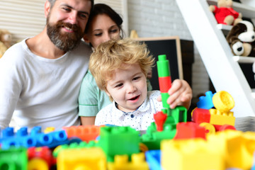 Young family spends time in playroom. Family and childhood