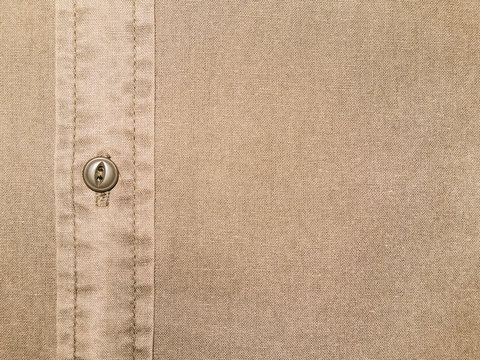 plain beige cotton shirt texture with button in close up