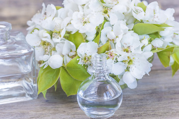 vials with pear flowers essential oil