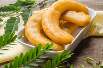 Pickled Tamarind Fruit on wooden background.