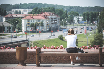 Girl sitting looking thinking city