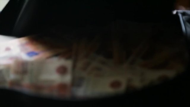 A black bag full of money in Russian currency. Concept on the topic of corruption and impunity of financial crimes in Russia. Russian money in the bag