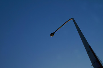 A telephone pole with super clean blue sky. Make me feel good.