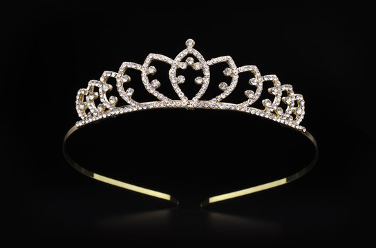 golden tiara with gems isolated on black background