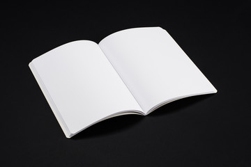 Mock-up magazine, book or catalog on black table. Blank page or notepad on solid background. Blank page or notepad for mockups or simulations.