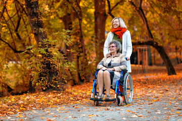 older woman on wheelchair with young woman in the park