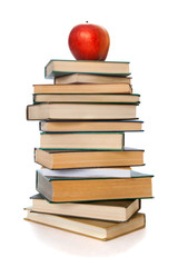 Book tower with apple isolated on white