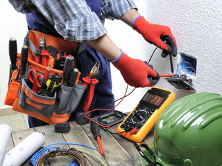 Young electrician technician works in compliance with safety standards in a residential electrical system.