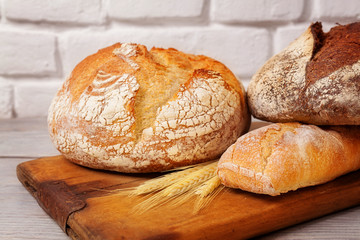 Fresh homemade bread assortment on old cutting board