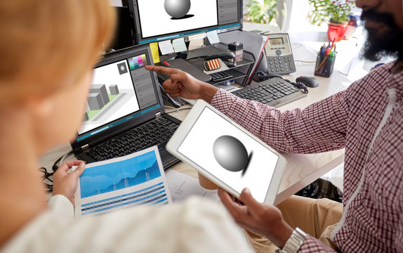 designers with 3d models on laptop and tablet pc