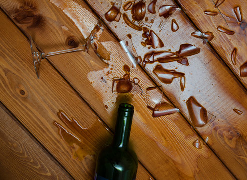 Broken Wine Glass With Bottle On  Table