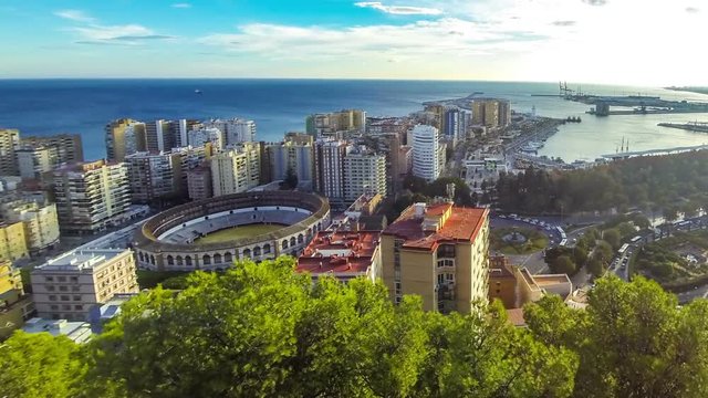 Panoramic aerial view of Malaga city, Costa del Sol, Andalusia, Spain. Cityscape of La Malagueta district with port and Toros de Ronda bullring. View from Gibralfaro castle. Tima Lapse