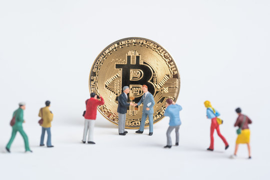 business miniature man shaking hand accept Cryptocurrency golden bitcoin ,digital currency - Powered by Adobe