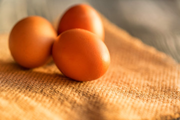 Fresh farm brown eggs on rustic background