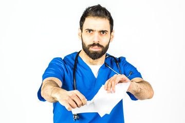 A portrait of a male doctor, tearing and tearing paper. Bad diagnosis, wrong treatment, lost,...