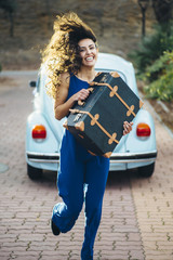 Obraz na płótnie Canvas beautiful woman with suitcase and car