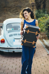 Obraz premium beautiful woman with suitcase and car