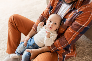 Obraz na płótnie Canvas happy father with little baby boy at home