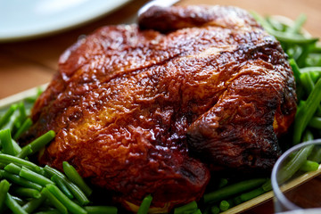 close up of roast chicken with green beans