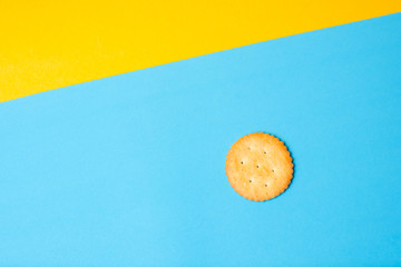 Cracker on solid light blue and yellow color background