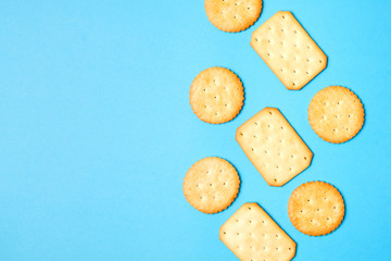 Crackers on solid light blue color background with copy space