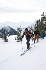 Young men ski touring in the mountains