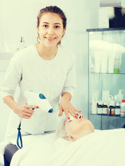 Aged woman making beauty procedures for face in spa salon