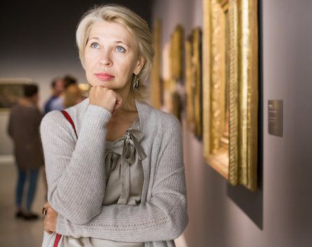  woman in art museum near the painting