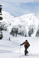 Fototapeta na wymiar Young man ski touring in the mountains